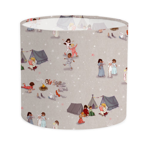 pack shot of child's lampshade with bedtime stories fabric design. it a grey starry background with images of children dancing, and reading campfire stories 