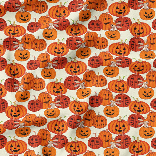 Fabric showing lots of orange carved Halloween pumpkins. Some of the pumpkins have Boo bunny poking out of the top. 